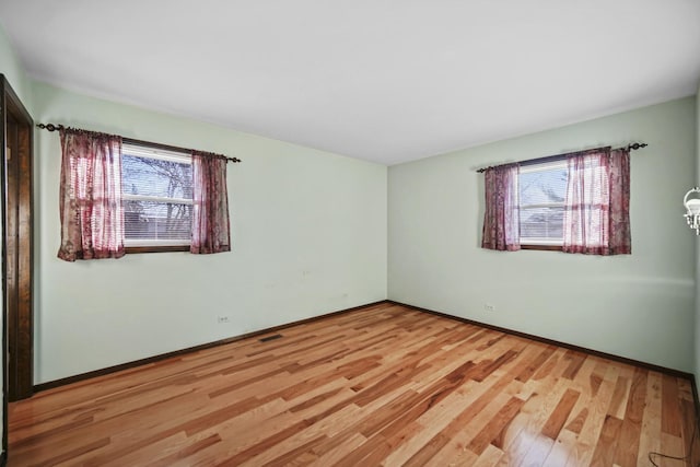 spare room with light wood-type flooring