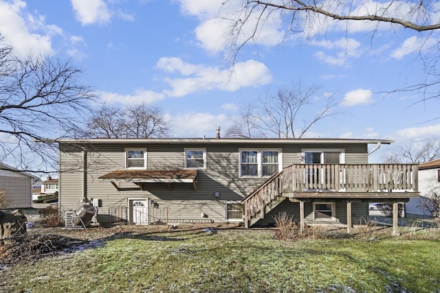 rear view of property featuring a yard and a wooden deck