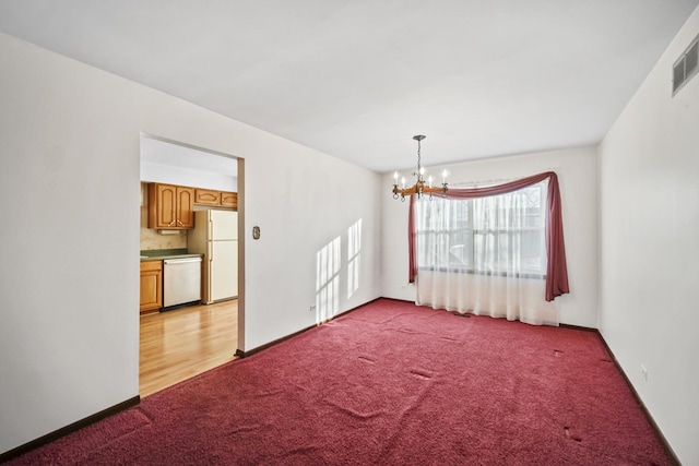 interior space featuring a notable chandelier and light carpet