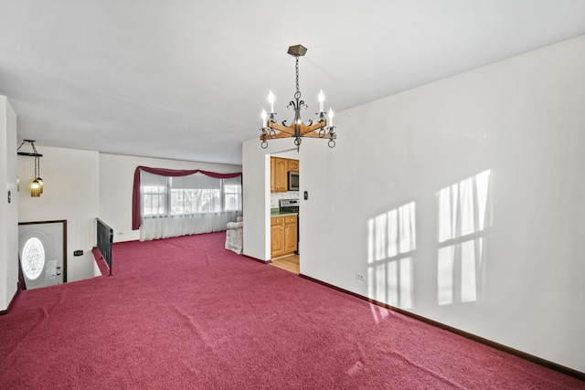 unfurnished bedroom featuring ensuite bath, light carpet, and an inviting chandelier