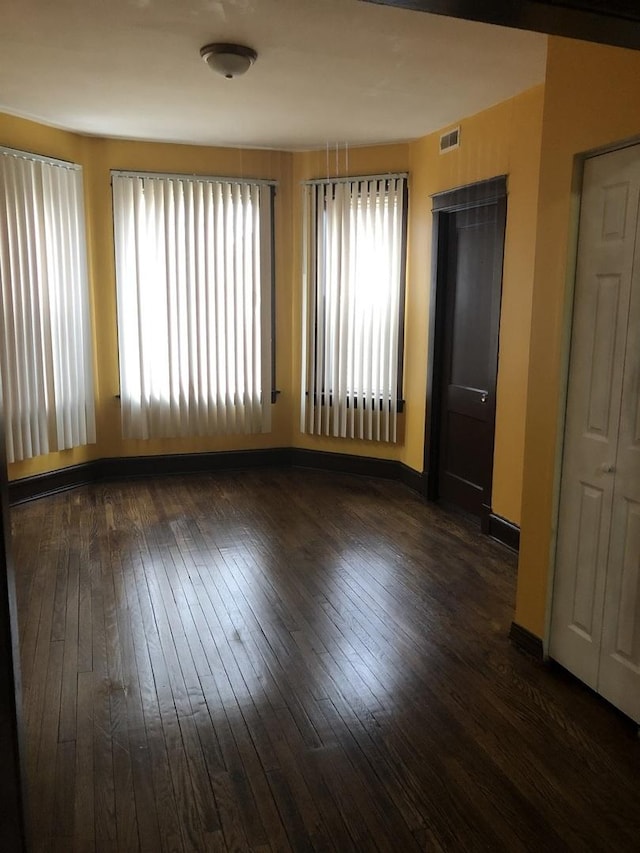 empty room featuring dark hardwood / wood-style flooring