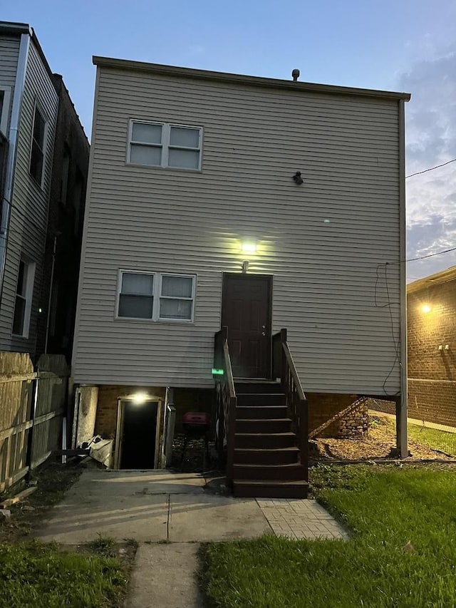 view of back house at dusk