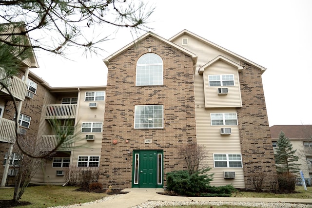 view of building exterior featuring an AC wall unit