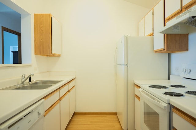 kitchen with white appliances, light hardwood / wood-style flooring, white cabinetry, and sink