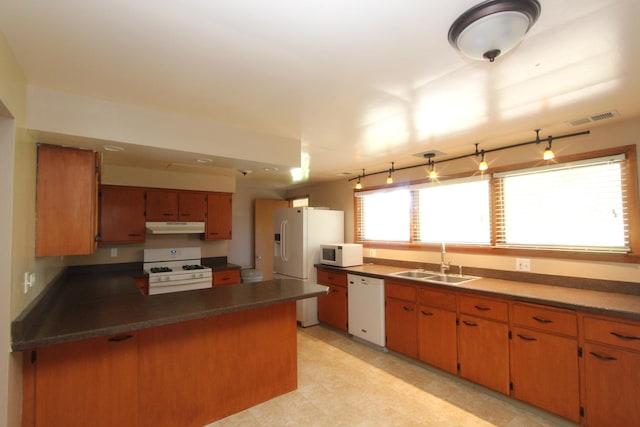 kitchen featuring kitchen peninsula, white appliances, and sink