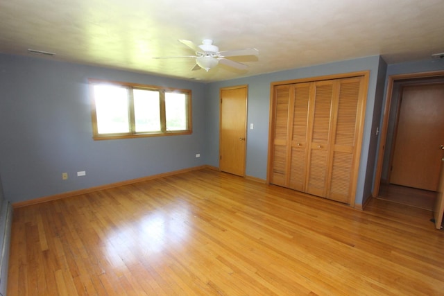 unfurnished bedroom featuring two closets, ceiling fan, and light hardwood / wood-style floors