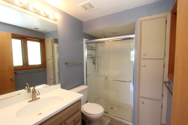 bathroom with toilet, an enclosed shower, and vanity