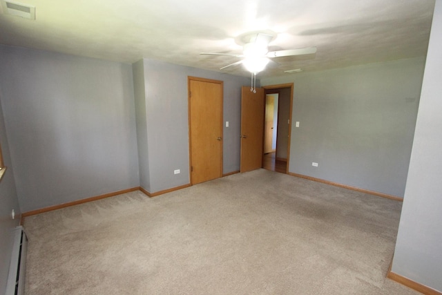 carpeted spare room featuring ceiling fan and baseboard heating