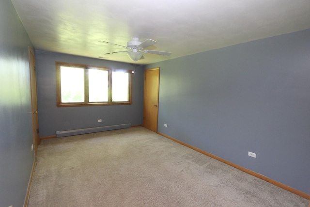 empty room with ceiling fan, light carpet, and a baseboard heating unit