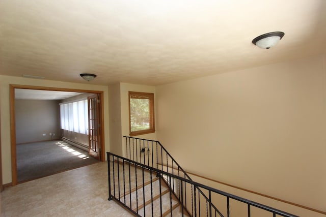 stairway with a baseboard radiator