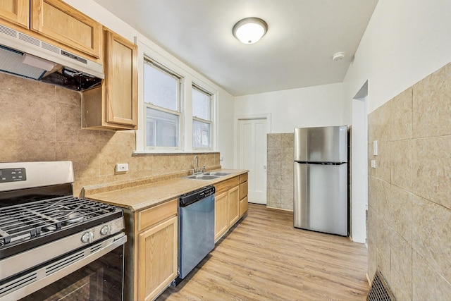 kitchen with light brown cabinets, sink, light hardwood / wood-style flooring, tasteful backsplash, and stainless steel appliances