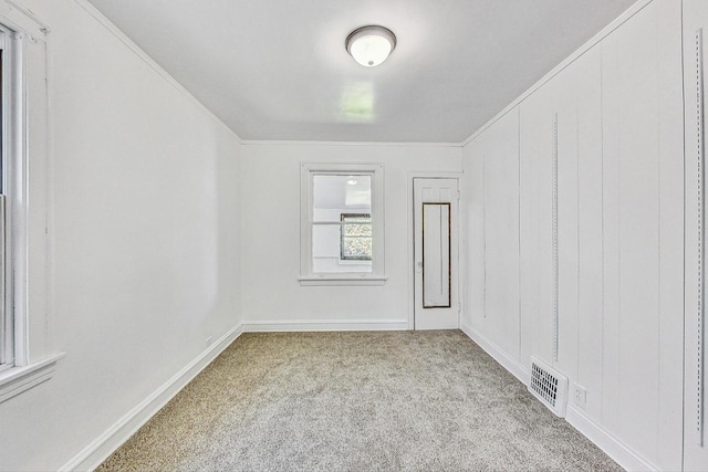 carpeted empty room featuring ornamental molding