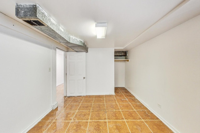 basement featuring tile patterned flooring