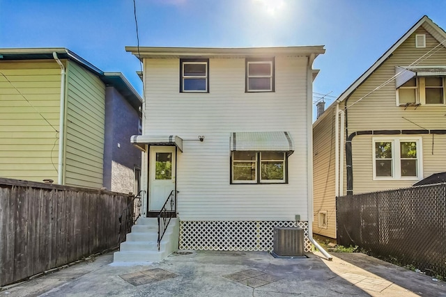 rear view of property featuring central air condition unit