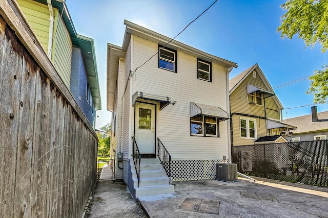 rear view of house with central air condition unit