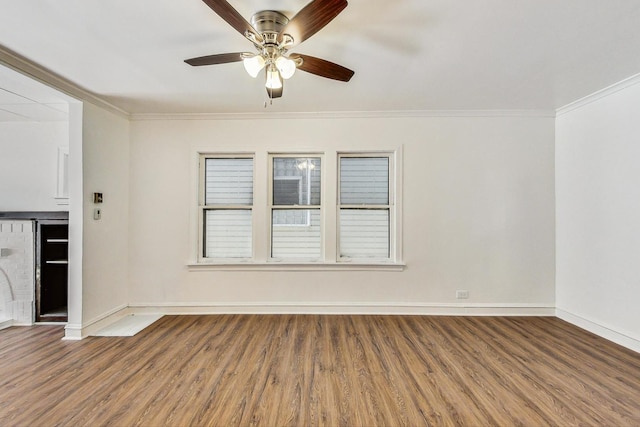 spare room with hardwood / wood-style flooring, ceiling fan, and crown molding