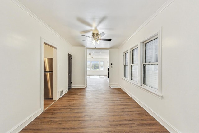 corridor featuring dark hardwood / wood-style flooring and crown molding