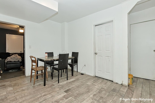 dining space featuring ceiling fan and light wood-type flooring