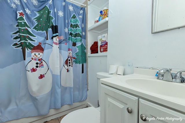 full bathroom featuring tile patterned flooring, vanity, toilet, and shower / tub combo with curtain