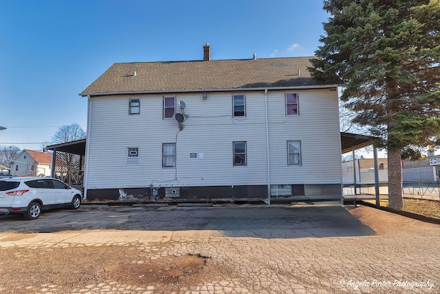 rear view of house with a carport