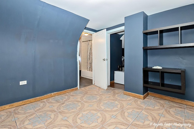 unfurnished bedroom with a closet and tile patterned flooring