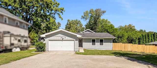 single story home featuring a garage and a front lawn