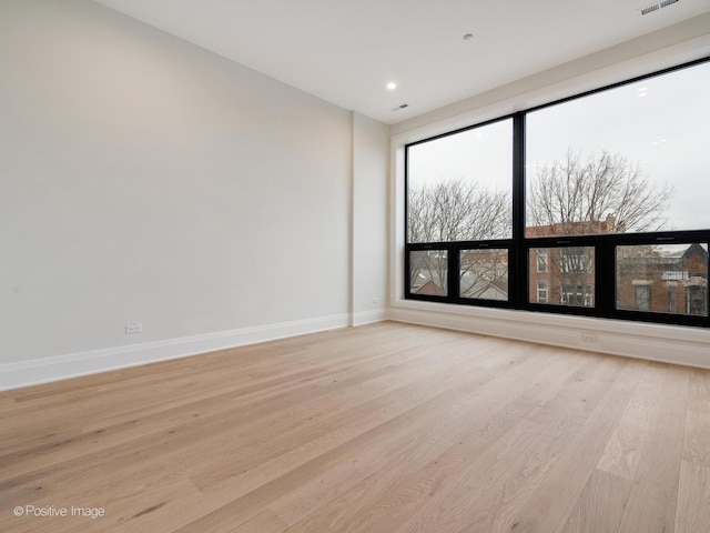 spare room featuring light hardwood / wood-style flooring