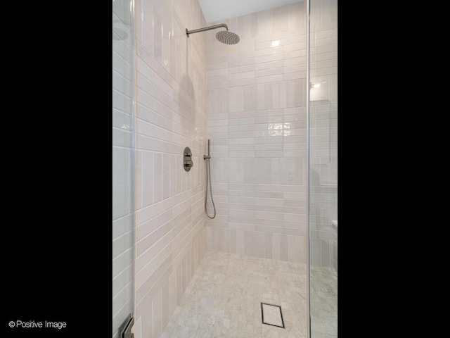 bathroom with a tile shower