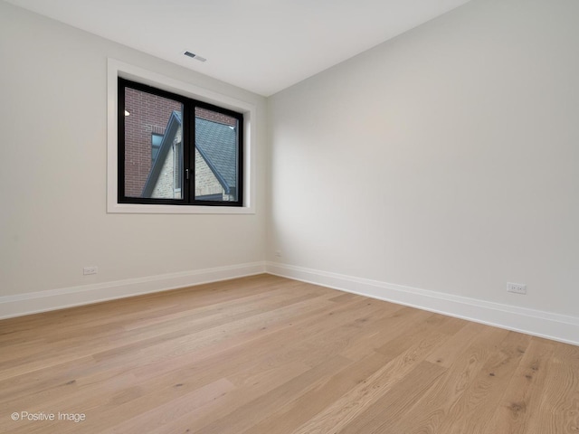 spare room featuring light hardwood / wood-style flooring