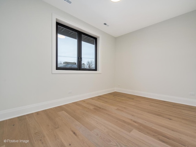 spare room with light hardwood / wood-style flooring