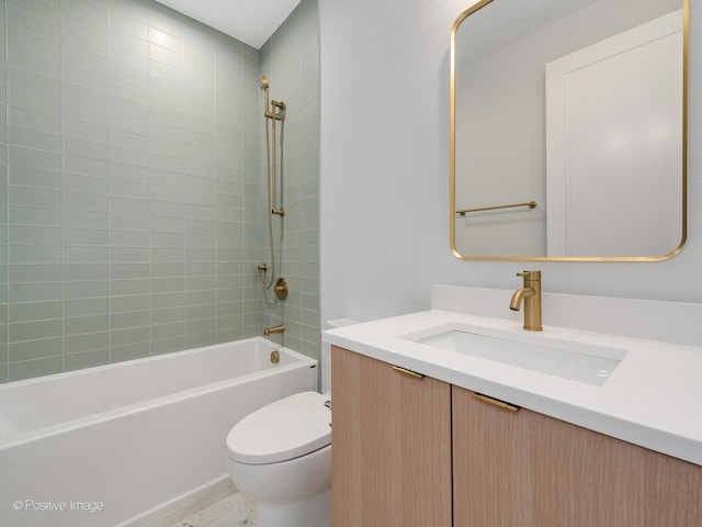 full bathroom with toilet, vanity, and tiled shower / bath