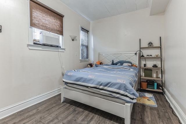 bedroom with dark hardwood / wood-style flooring, multiple windows, and ornamental molding