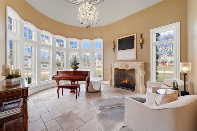 interior space featuring a premium fireplace and a notable chandelier