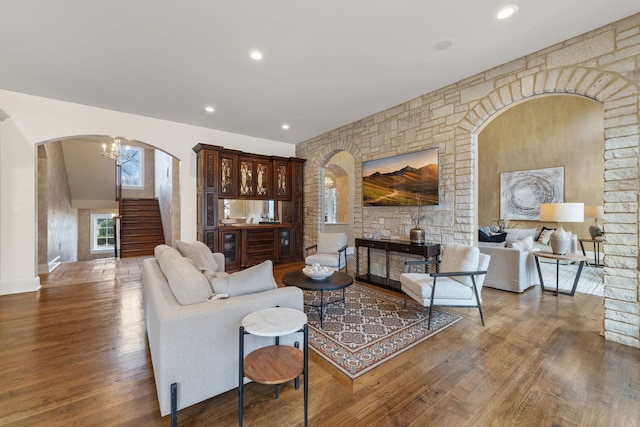 living room featuring hardwood / wood-style floors, beverage cooler, and a notable chandelier