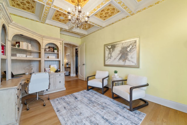 office area featuring crown molding, light hardwood / wood-style flooring, a chandelier, and coffered ceiling