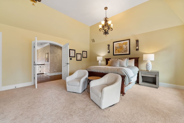 bedroom featuring light carpet, a chandelier, and vaulted ceiling