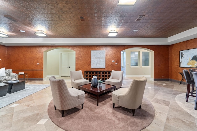 living room featuring brick ceiling