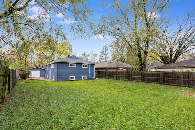 view of yard featuring a garage and an outdoor structure