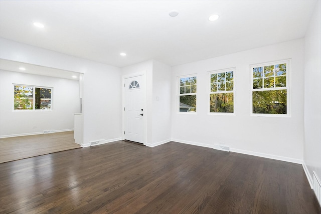 unfurnished room with dark wood-type flooring