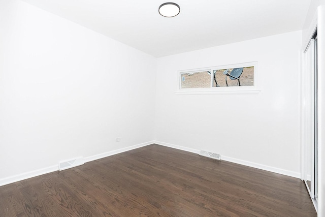 unfurnished room with dark hardwood / wood-style floors