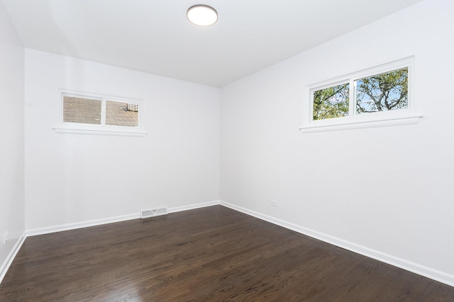 spare room with dark hardwood / wood-style floors