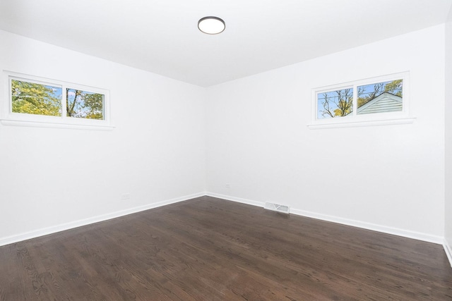 empty room featuring dark hardwood / wood-style floors