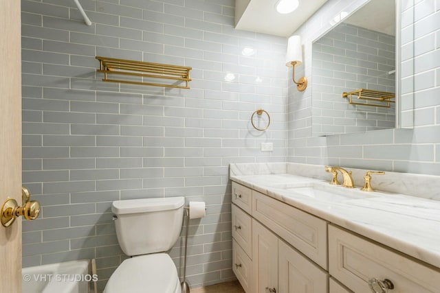 bathroom featuring a shower, vanity, and toilet