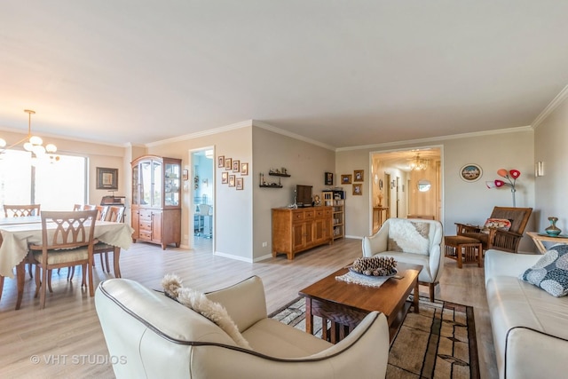 living room featuring ornamental molding, light hardwood / wood-style floors, and an inviting chandelier