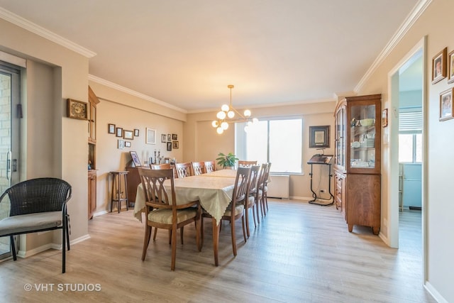 dining area featuring a wealth of natural light, ornamental molding, light wood-type flooring, and a notable chandelier