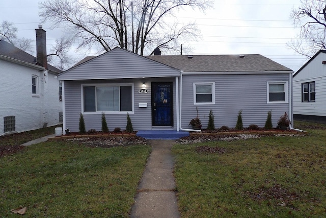 bungalow-style home with a front lawn