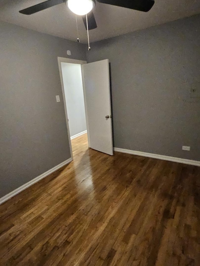 spare room with dark hardwood / wood-style flooring