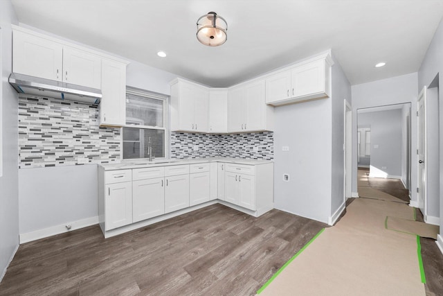 kitchen featuring white cabinets, dark hardwood / wood-style floors, tasteful backsplash, and sink