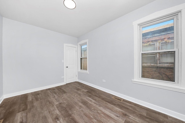 spare room with dark hardwood / wood-style floors