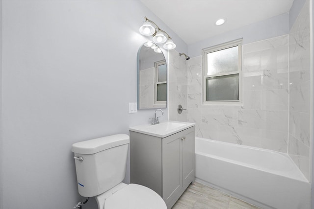 full bathroom featuring tiled shower / bath combo, toilet, and vanity